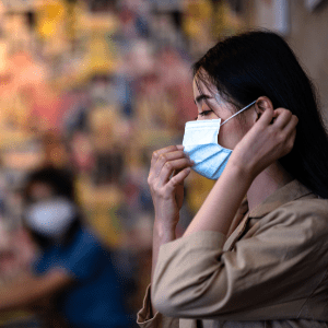 Woman adjusting a face mask in profile