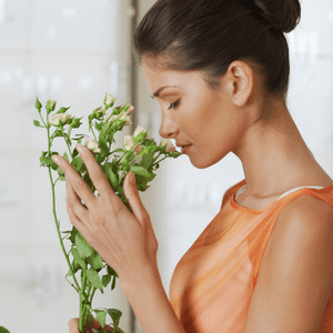 woman smells a bouquet of flowers